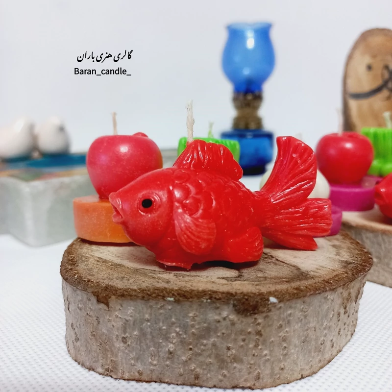 شمع دست ساز هفت سین (سبزه،سیر،سیب و ماهی) با کفه ی تنه ی درخت مناسب عیدی و هدیه